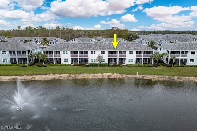 exterior space featuring a water view and a yard