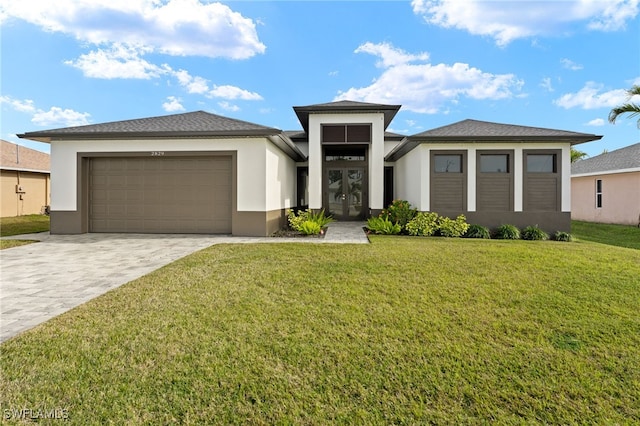 prairie-style home with a garage, a front lawn, and french doors