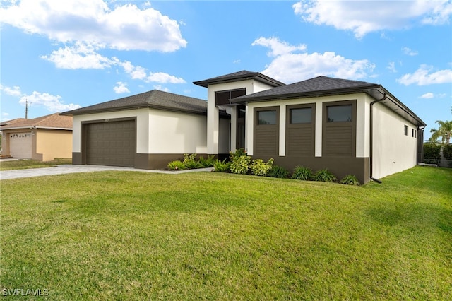 prairie-style house with a garage and a front lawn