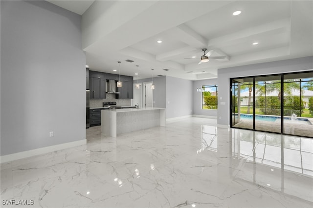 unfurnished living room with sink, coffered ceiling, beamed ceiling, and ceiling fan