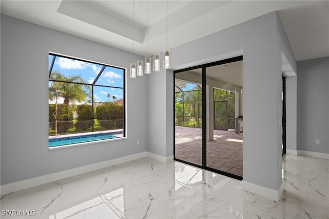 unfurnished dining area featuring a raised ceiling