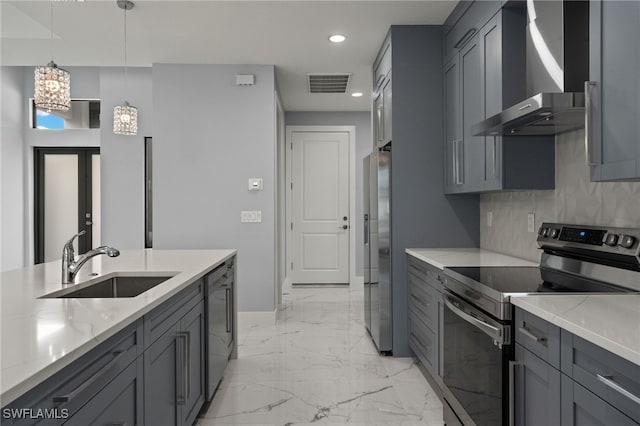 kitchen featuring tasteful backsplash, gray cabinetry, light stone countertops, and stainless steel appliances