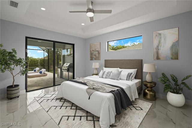 bedroom featuring access to outside, ceiling fan, and a raised ceiling