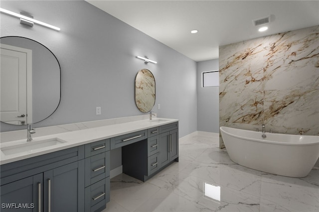 bathroom featuring a tub and vanity