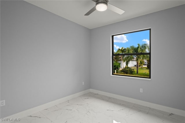 empty room featuring ceiling fan and plenty of natural light