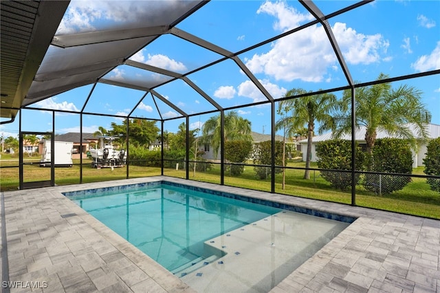 view of pool with a patio area, a lanai, and a lawn