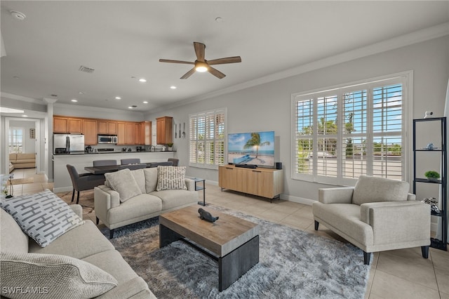 living room with light tile patterned floors, crown molding, and ceiling fan