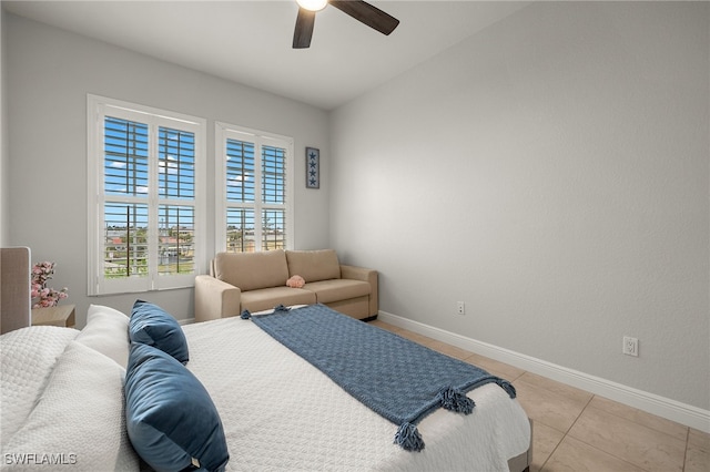 tiled bedroom featuring ceiling fan