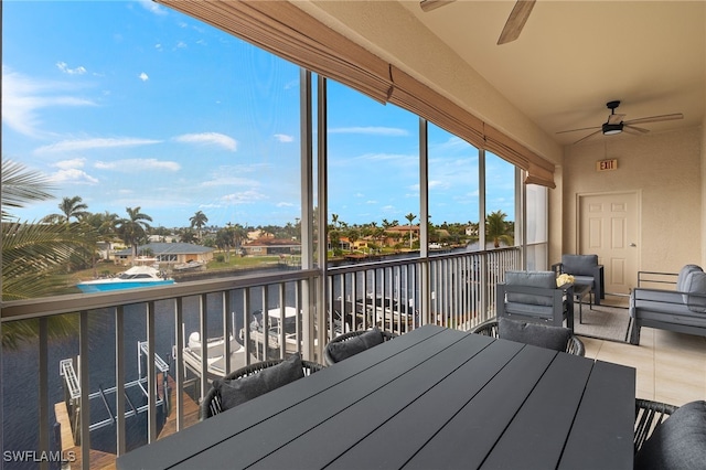 unfurnished sunroom with ceiling fan