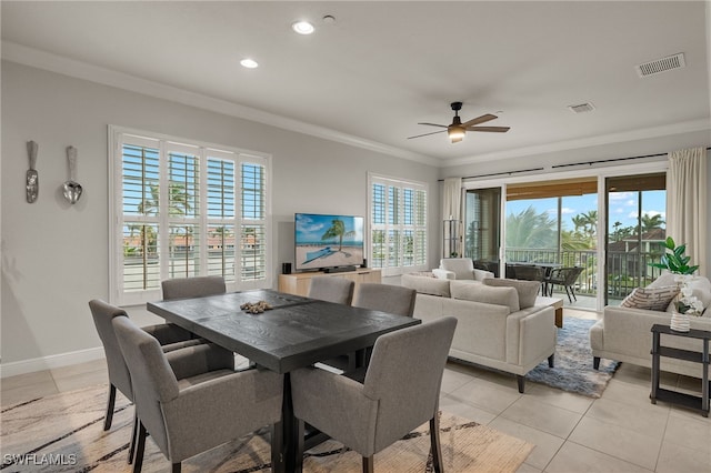 dining room with ornamental molding, light tile patterned floors, and ceiling fan