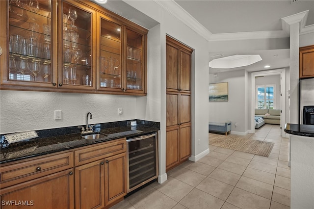 bar featuring sink, dark stone countertops, wine cooler, crown molding, and stainless steel refrigerator with ice dispenser