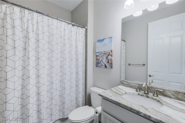 bathroom with walk in shower, vanity, and toilet