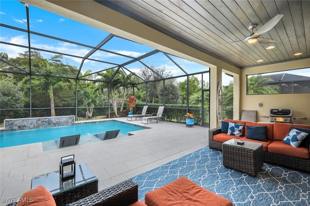 view of pool with an outdoor living space, a patio, a lanai, ceiling fan, and pool water feature