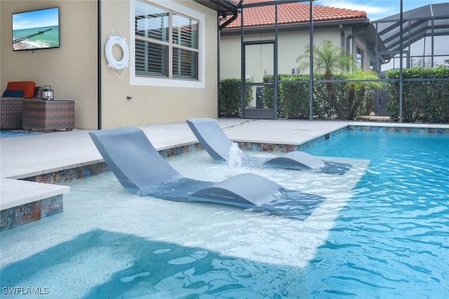 view of pool with a lanai and a patio area