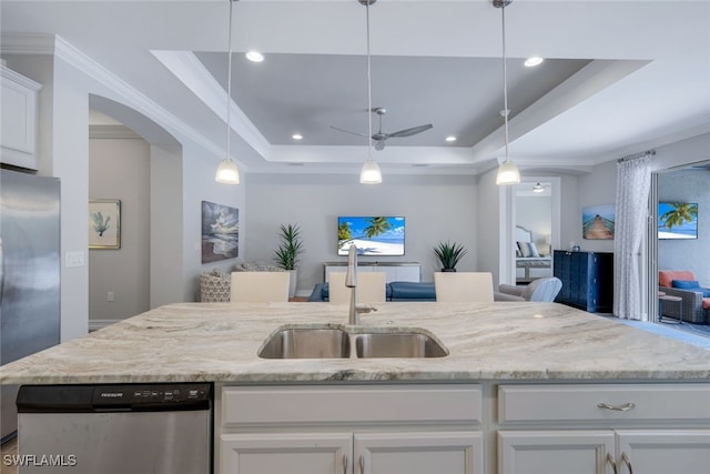 kitchen with stainless steel appliances, sink, white cabinetry, a raised ceiling, and ceiling fan