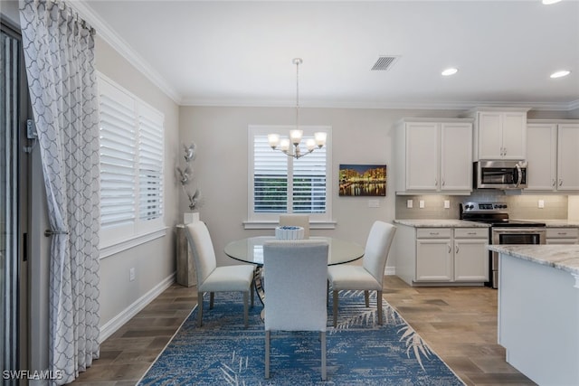 dining room featuring a notable chandelier, crown molding, and hardwood / wood-style flooring