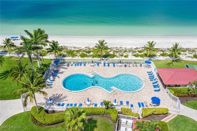 drone / aerial view featuring a beach view and a water view