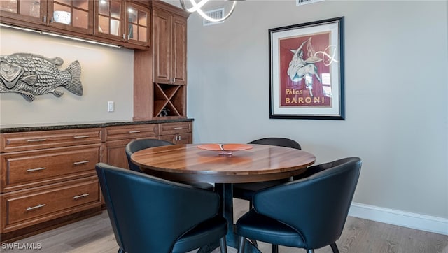 dining space with light wood-type flooring