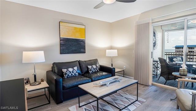 living room with ceiling fan and light hardwood / wood-style floors