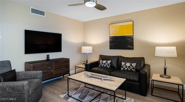 living room featuring ceiling fan and hardwood / wood-style floors