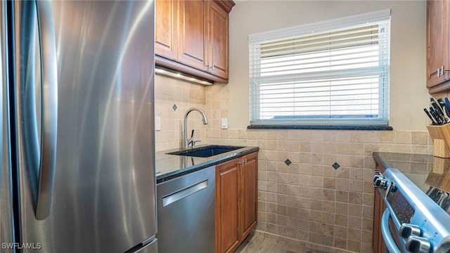 kitchen featuring sink, tile walls, a healthy amount of sunlight, and appliances with stainless steel finishes