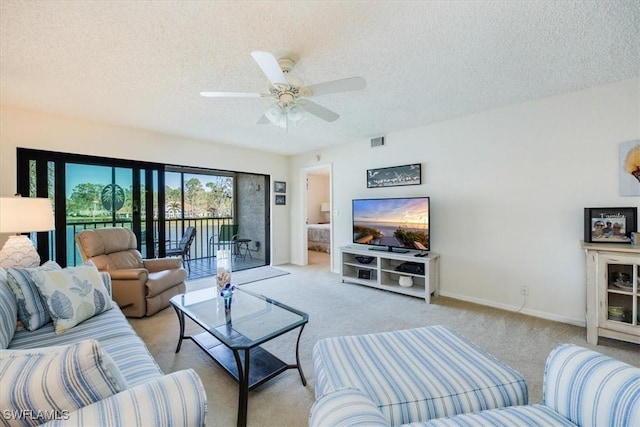 living room with visible vents, a textured ceiling, and carpet floors