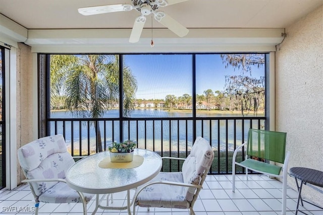 sunroom featuring a water view, a healthy amount of sunlight, and ceiling fan