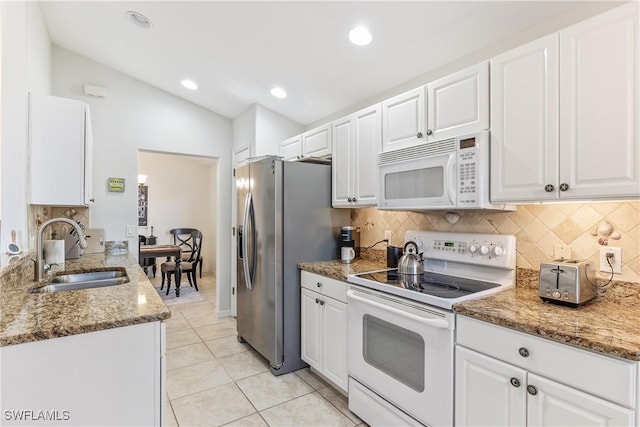 kitchen with sink, white appliances, white cabinetry, and light tile patterned flooring