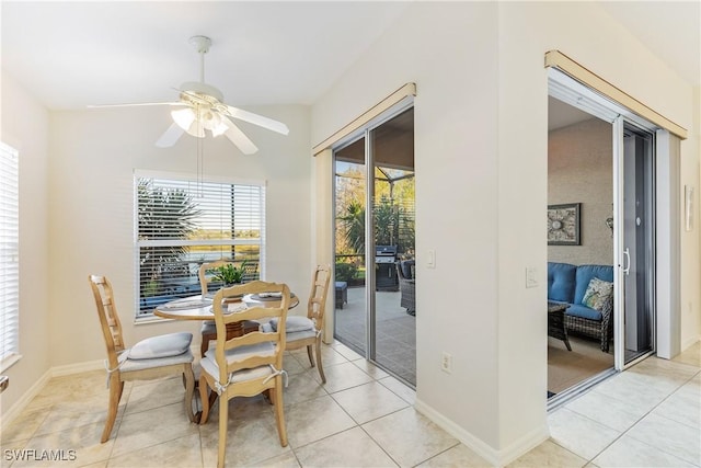 tiled dining space with ceiling fan