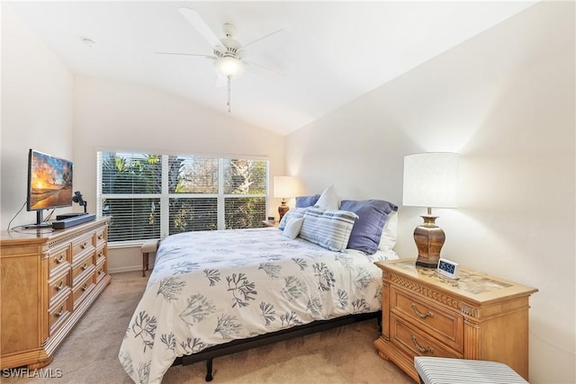 carpeted bedroom with ceiling fan and vaulted ceiling