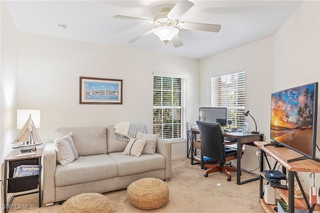 office space with ceiling fan and light colored carpet