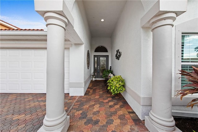 doorway to property with a garage