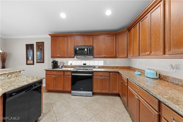 kitchen with light stone counters, black appliances, and ornamental molding