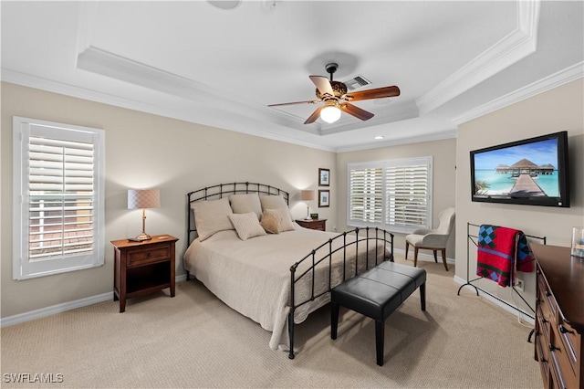 bedroom featuring ceiling fan, ornamental molding, light colored carpet, and a tray ceiling