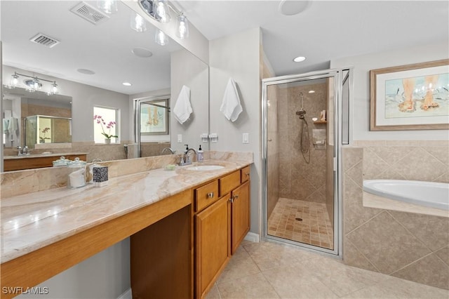 bathroom featuring independent shower and bath, tile patterned floors, and vanity