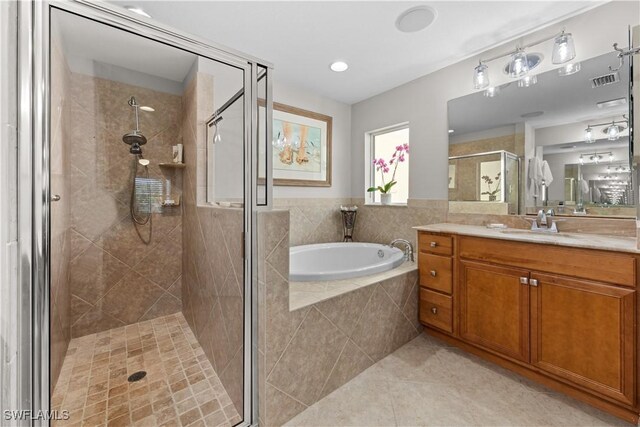 bathroom featuring vanity, tile patterned flooring, and shower with separate bathtub