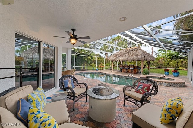 view of swimming pool featuring glass enclosure, a patio area, exterior bar, and an in ground hot tub