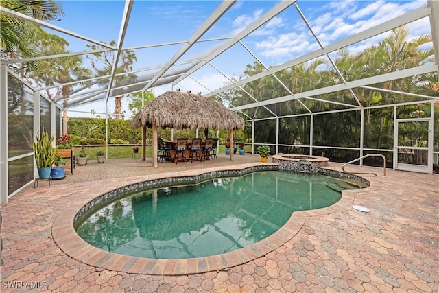 view of swimming pool with glass enclosure, a gazebo, an in ground hot tub, and exterior bar