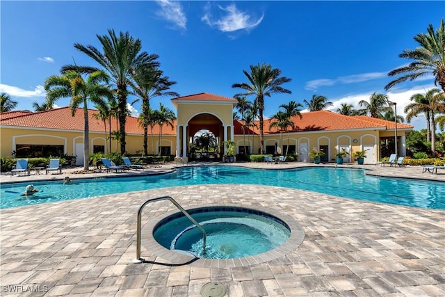 view of pool with a community hot tub and a patio area