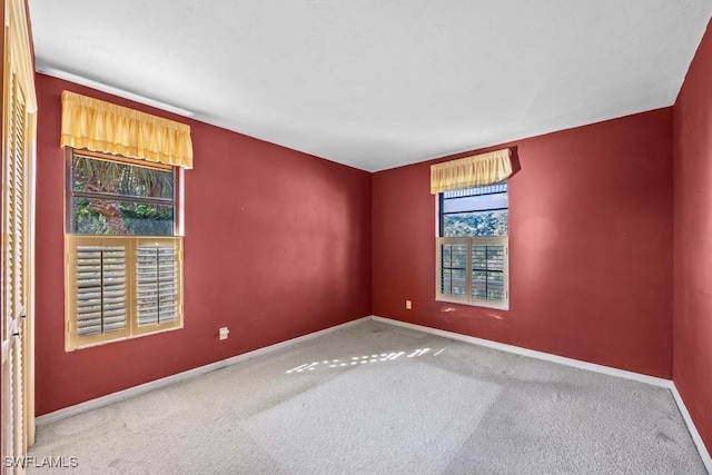 carpeted spare room with plenty of natural light