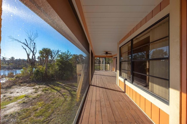 wooden terrace featuring a water view