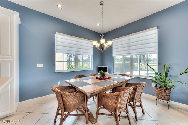 dining area featuring light tile patterned flooring, an inviting chandelier, and a healthy amount of sunlight