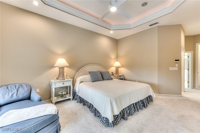 bedroom featuring ceiling fan, ornamental molding, carpet floors, and a tray ceiling