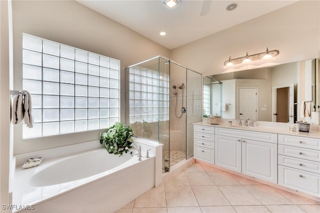 bathroom featuring tile patterned floors, vanity, and separate shower and tub