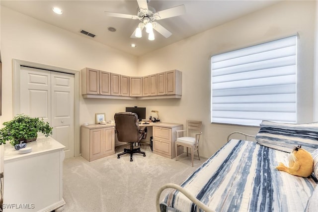 carpeted bedroom featuring ceiling fan and a closet