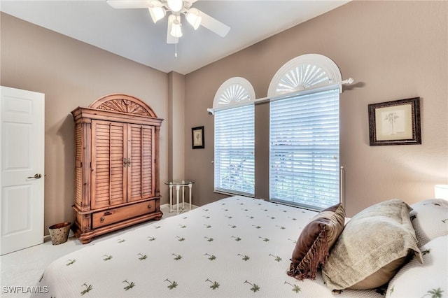 bedroom featuring ceiling fan and carpet