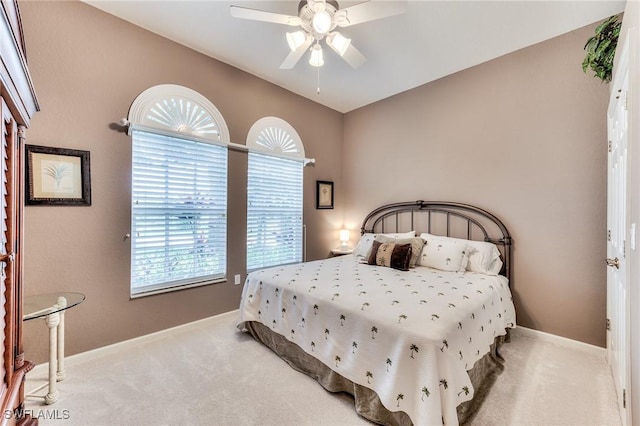 bedroom with ceiling fan and light carpet