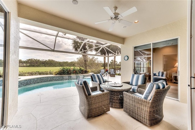 view of patio with ceiling fan, outdoor lounge area, and a lanai