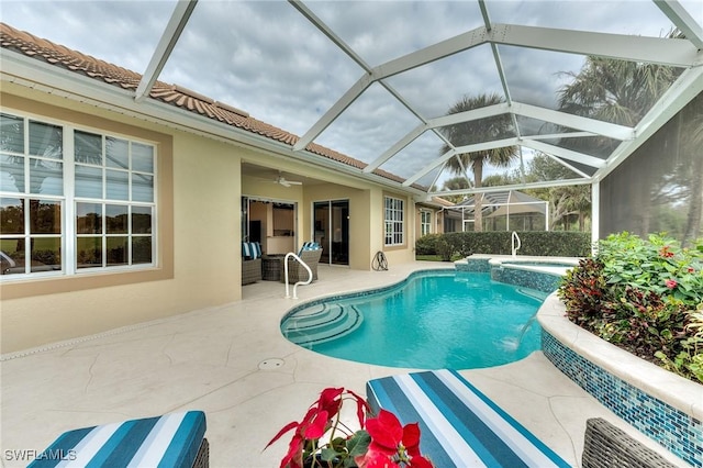 view of swimming pool with a lanai, ceiling fan, an in ground hot tub, and a patio