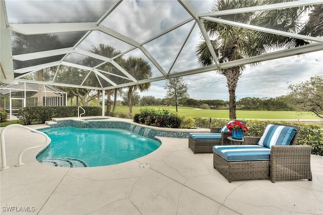 view of pool with glass enclosure, pool water feature, a patio area, and an in ground hot tub